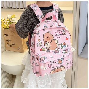 Detailed view of pink school bag with cute cartoon bear and strawberry prints