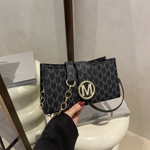 Fashionable black square crossbody bag with grey M pattern and gold metal logo buckle