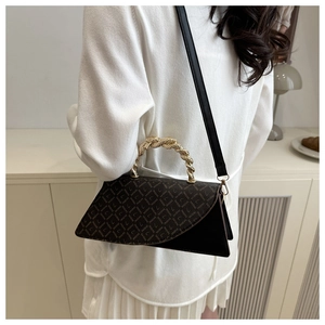 Detail of vintage leopard print crossbody bag with metallic woven rope handle and flap