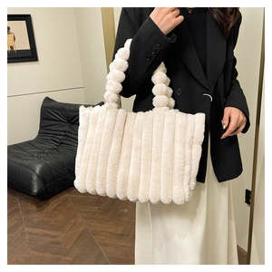 Macro detail of cream plush tote bag with vertical stripes and bubble handle texture