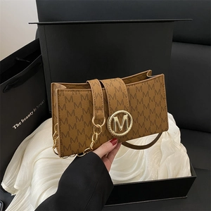 Brown rectangular crossbody bag with letter print and golden M logo on luxury gift box