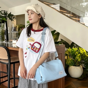 Light blue canvas cylinder crossbody bag for couples in casual streetwear style
