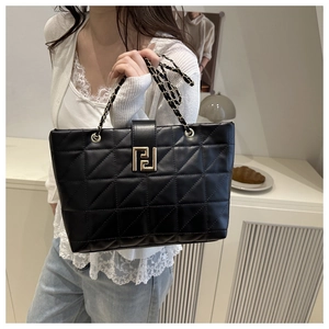 Classic black quilted leather tote bag with elegant gold geometric metal lock and chain strap