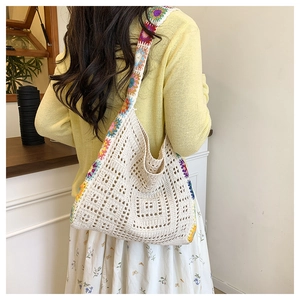 Detailed knit tote bag with boho floral patterns and hollow crochet textures