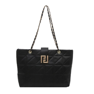 Minimalist black quilted tote bag with golden geometric clasp and chain strap on white background