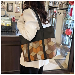 Detail einer großen Patchwork-Tasche mit 3D-Geometriemuster und schwarzem Leder