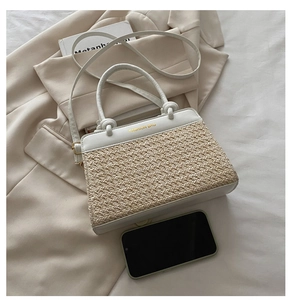 Detail of straw patchwork crossbody bag with leather top and gold fashion bag logo