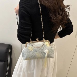 Elegant floral Chinese style handbag with gold chain strap shown on a model