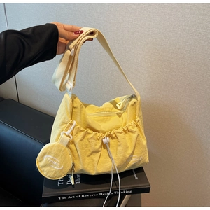 Minimalist bright yellow drawstring shoulder bag with matching round coin purse detail