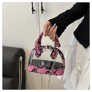 Detail of mini clear PVC shell bag with pink and black snakeskin trim and silver chain