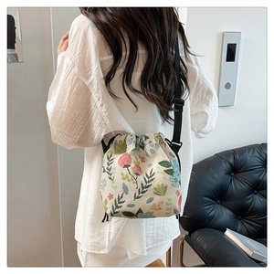 Detailed shot of a floral jacquard drawstring bucket bag with colorful flower patterns