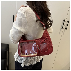 Model wearing a vintage red PU leather shoulder bag with clear display pockets and bow zip