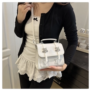 Detail of white star-patterned crossbody bag with Fashion HAPPINESS embossed text