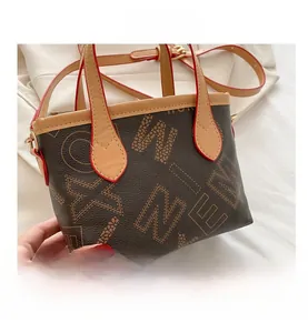 Detail shot of mini bucket tote bag with WINE print and red painted edge finish