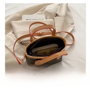 Detail view of the spacious inner compartment of the brown leather bucket tote bag