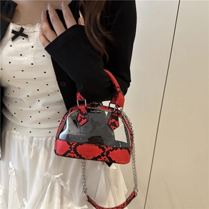 Fashionable shell-shaped crossbody bag with red snake skin pattern and clear PVC detail