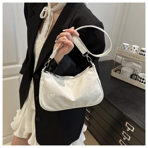 Detail showing white snake pattern leather texture and silver metal zipper on the handbag