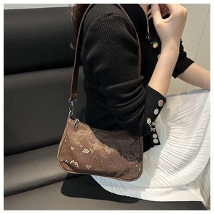 Brown snakeskin pattern underarm bag shown with casual outfit for elegant styling