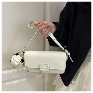 Detail of white lychee texture baguette bag with square buckle and mini coin pouch