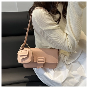 Pink lychee texture baguette shoulder bag styled with white dress and mini pouch charm