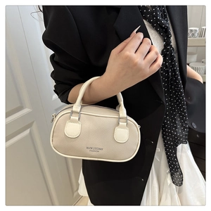 Detailed macro view of the soft beige textured PU leather and silver metal buckles