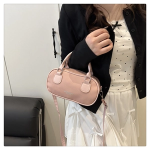 Pink litchi texture leather bowling bag featuring sleek handles and silver logo detail