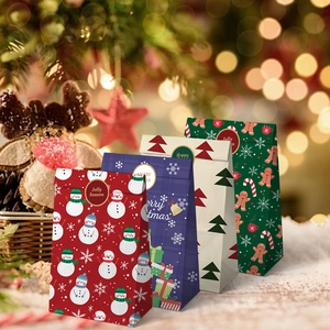Christmas paper gift bags with snowman and gingerbread man designs for holiday treats