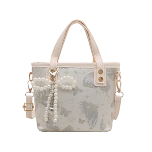 Sac à main beige brodé papillon avec breloque nœud en perles et bandoulière réglable