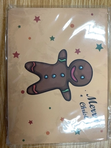 Detail of vintage Christmas gingerbread man greeting card set with envelopes