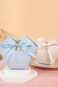 Detail of luxury PU leather wedding candy bags with pearl and ribbon bow decoration