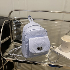 Lavender quilted chain backpack with diamond pattern and silver metal clasp on display