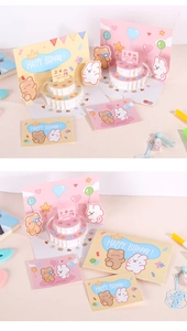 Detailed view of 3D pop-up birthday card with cartoon bear, rabbit, and cake layers