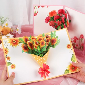 3D pop-up greeting card featuring sunflower and carnation designs with a red bow