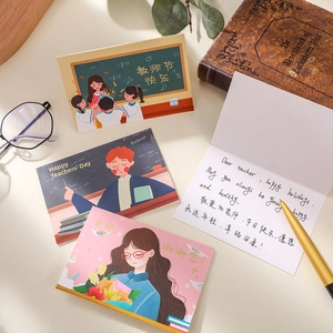 Detail view of gold-stamped Teacher's Day greeting cards with artistic school illustrations