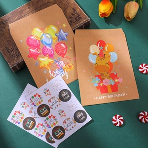 Close-up of birthday gift bags with cartoon giraffe and rainbow on green background
