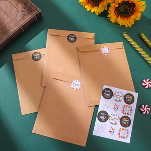 Close-up of kraft paper envelopes and round stickers with festive birthday greetings