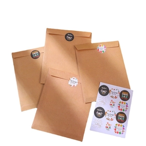 Brown kraft envelopes set with colorful Happy Birthday stickers for creative gift packaging
