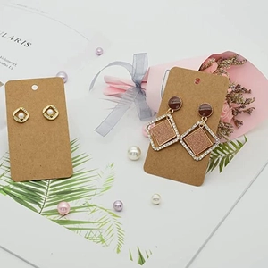 Elegant earrings set on kraft paper cards with pearl and rhinestone details