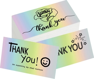 Close-up of holographic thank you cards with iridescent finish and floral art