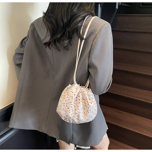 Floral drawstring bucket bag with red flower pattern on white canvas for women
