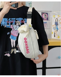 Vue détaillée d'un sac de poitrine en toile blanche avec texte OOXBAG rose et ourson