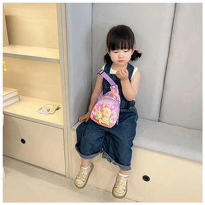 Toddler wearing a purple Capybara crossbody chest bag with adjustable strap detail