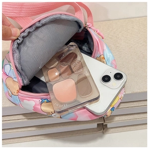 Internal view of pink cartoon chest bag showing capacity for phone and cosmetics