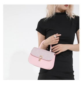 Détail du petit sac carré en cuir rose avec rabat à paillettes et fermoir doré