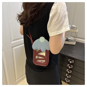 Detailed back view of model wearing cherry cupcake crossbody mobile bag with hollow lattice