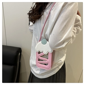 Crossbody bag shaped like a pink cupcake with white frosting and cherry top detail