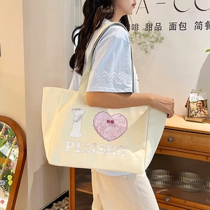 Cream canvas tote bag with cartoon heart print and long shoulder straps for women