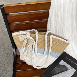Three-color striped woven tote bag with cotton rope handles and beige lace bow detail