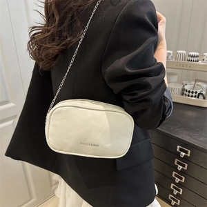 White minimalist leather chain crossbody bag with silver hardware for modern women