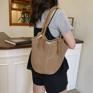Woven straw tote bag with tassels and mesh texture for summer casual beach vacation
